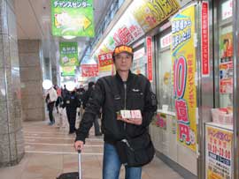 今日買った東京2020ジャンボ宝くじを持って売場の前で記念撮影